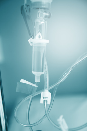 Close up saline IV drip for patient and Infusion pump in hospital.の写真素材