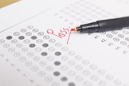 Standardized test form with answers bubbled in and a pencil, focus on anser sheet