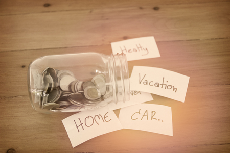 Money in glass jar with home label, financial concept.の写真素材