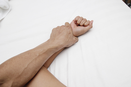 A hairy man's hand holding a woman hand for rape and sexual abuse conceptの写真素材