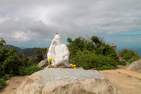 Statue of eastern sage with chessboard on top of the hill near Danang, Vietnamの写真素材
