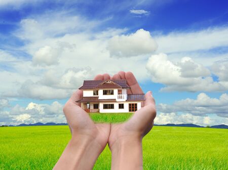 Hand holding new house の写真素材