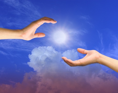 A hand is reaching out in the sky for help の写真素材