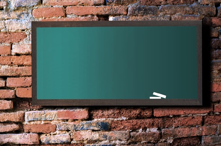 Green board on old wall Brick mortar background の写真素材