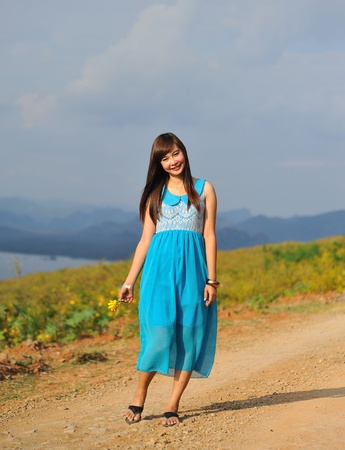 beautiful young girl in a meadow in summer の写真素材