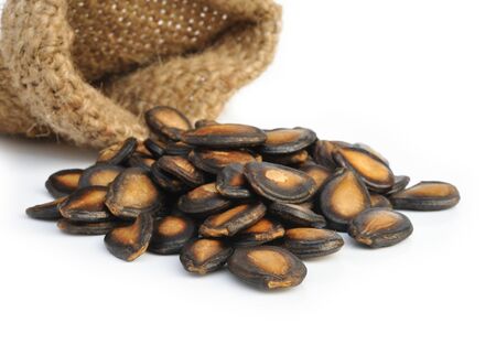 Black Melon Seeds on white background の写真素材