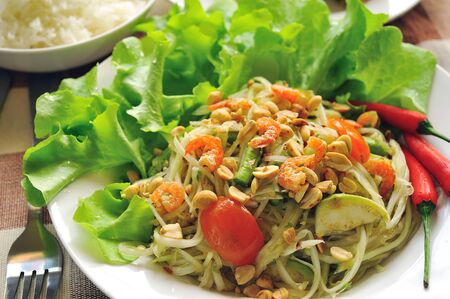 Somtum Thai food and spicy food on a white dish の写真素材