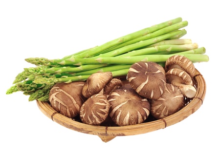 Mushrooms and asparagus in a basket.の写真素材