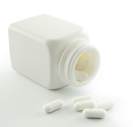 Pills spilling out of pill bottleの写真素材