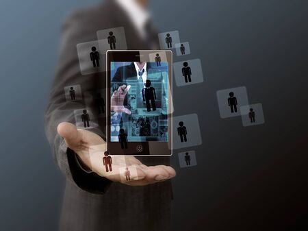 businessman holding mobile phone  Choosing the right personの写真素材