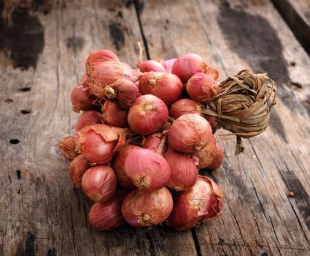 Shallot onions in a group on woodの写真素材