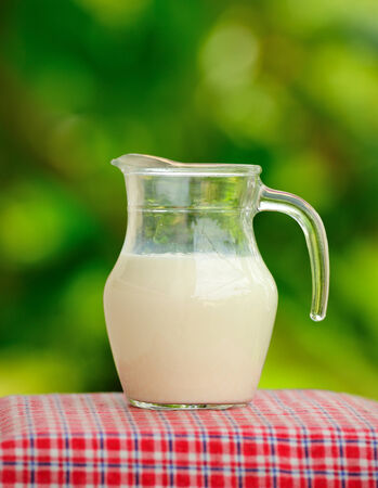 Pitcher of milk  in the garden.の写真素材
