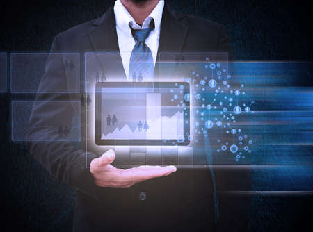 Business man hold Tablet computer and graph reportの写真素材