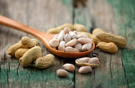 peanuts in the woodspoon on wood
