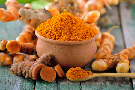 turmeric roots in the basket on wooden tableの写真素材