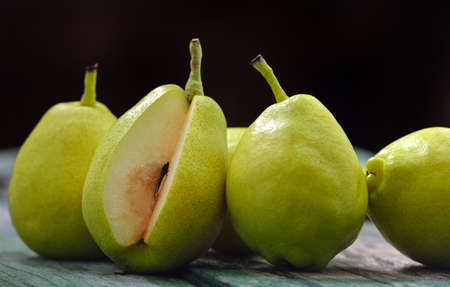Green pears on a rustic woodenの写真素材
