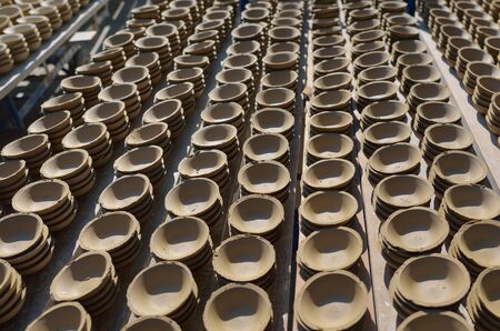 Ceramic cup in rack prepare for bring in furnace in factoryの写真素材