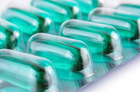 Blue Transparent pills content medicine capsule on white background