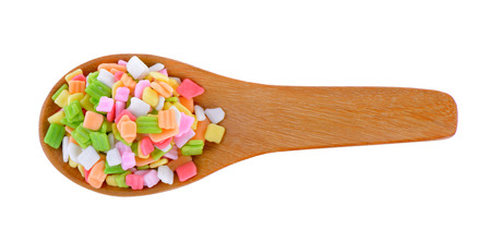 colorful candy in wood spoon on white backgroundの写真素材