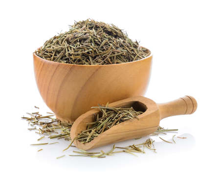 Dried rosemary leaves in wood bowl on white backgroundの写真素材