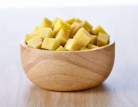 ginger sliced in wood bowl