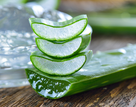 aloe vera gel in bowl with on wooden tableの写真素材