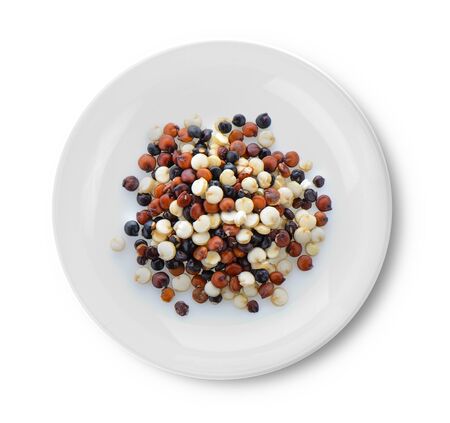 Quinoa seeds in plate on white backgroundの写真素材