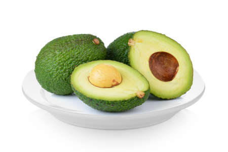 avocado in white plate on white backgroundの写真素材