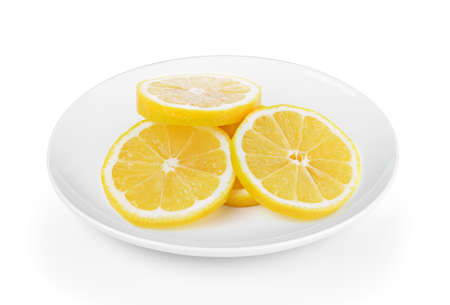 Fresh lemon slices in plate on white backgroundの写真素材