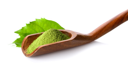 green tea powder in scoop on white backgroundの写真素材