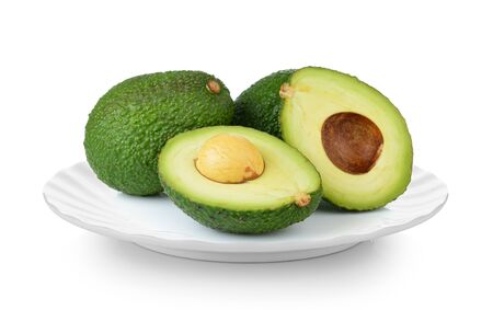 avocado in white plate on white backgroundの写真素材