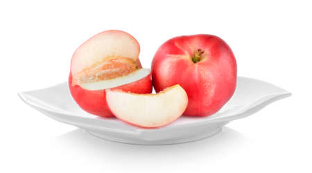 Peach in plate on white backgroundの写真素材