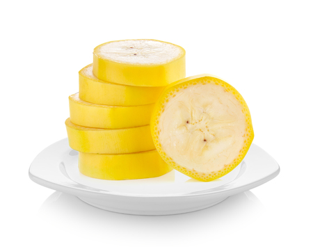 Banana slice in white plate on white backgroundの写真素材