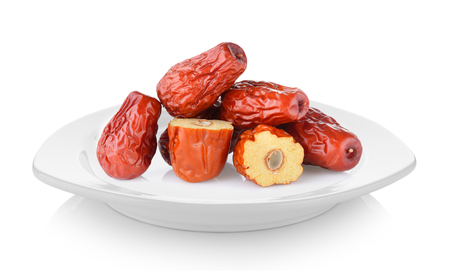 Dried red date or Chinese jujube in white plate on white backgroundの写真素材