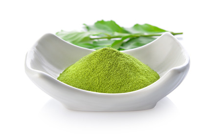 green tea powder in a bowl on white backgroundの写真素材