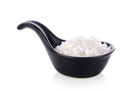 salt in spoon on white backgroundの写真素材
