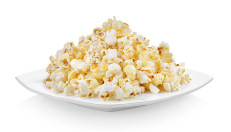 Popcorn in white plate on white backgroundの写真素材