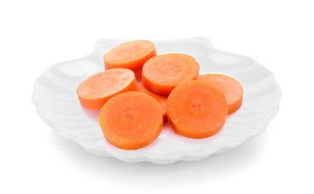 carrot slices in ceramic plate on white backgroundの写真素材