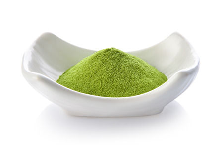 green tea powder in a bowl on white backgroundの写真素材