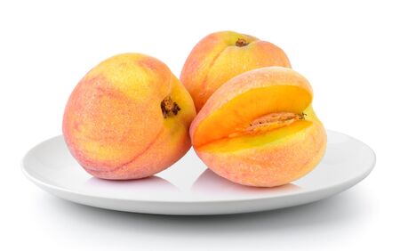 Peach in a plate isolated on a white backgroundの写真素材