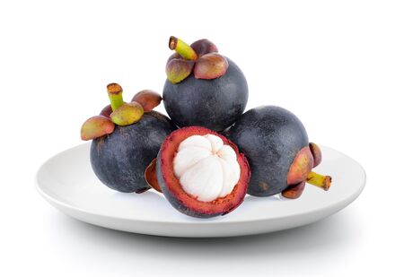 mangosteen in a plate isolated on a white backgroundの写真素材