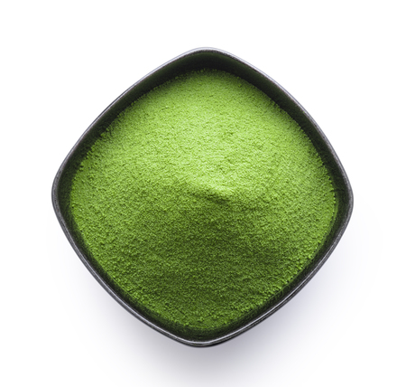 green tea powder in a bowl on white backgroundの写真素材