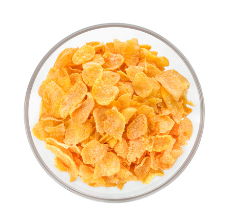 corn flakes in a bowl on white backgroundの写真素材