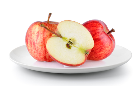 red apple in a plate isolated on a white backgroundの写真素材
