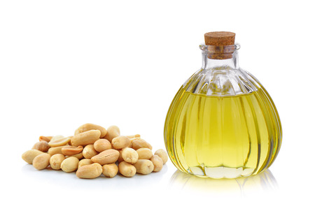 Oil bottle and peanuts on white backgroundの写真素材