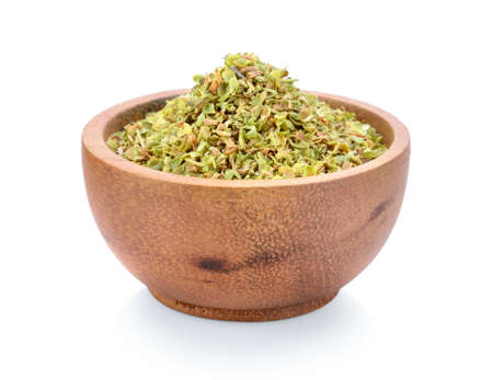 Dried spice of oregano herbs in wood bowl on white backgroundの写真素材