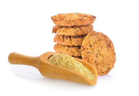 Oatmeal cookies and wheat germ in wood scoop on white backgroundの写真素材