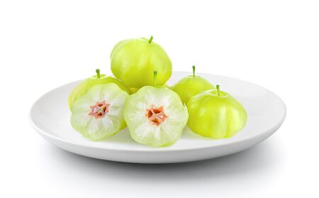 star gooseberry in a plate isolated on a white backgroundの写真素材