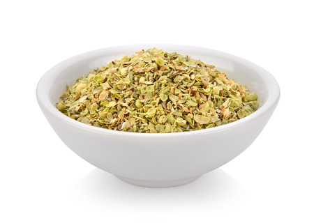 Oregano spice in a bowl on white backgroundの写真素材