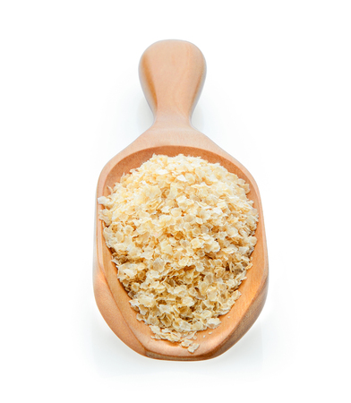 amaranth seeds on wooden scoop over white backgroundの写真素材
